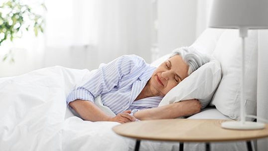 Elder person sleeping comfortably in bed