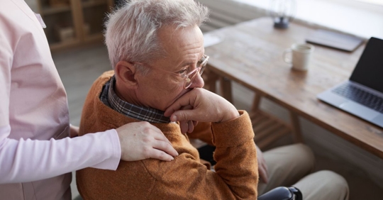 man in nursing home being comforted