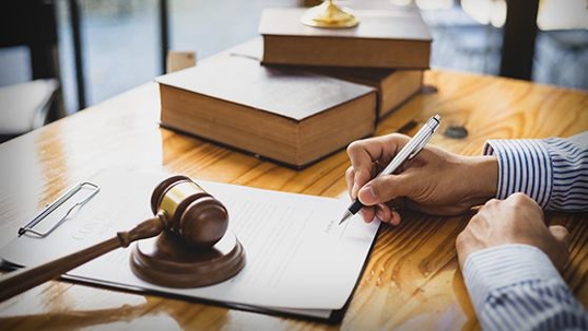 Person writing on paperwork